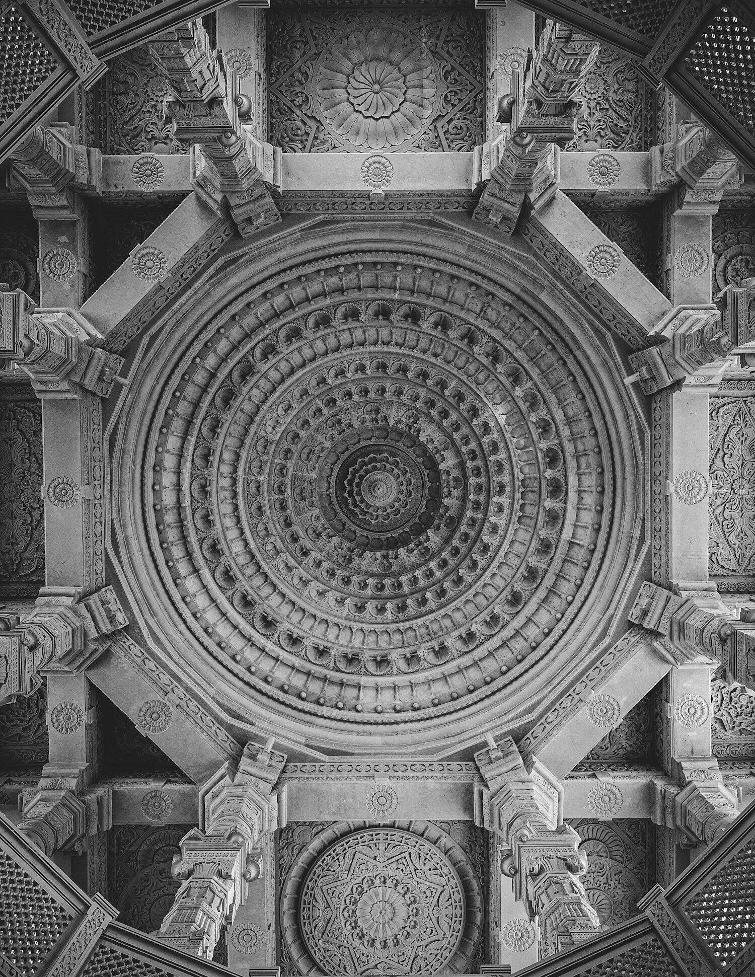 Intricate circular mandala pattern carved into ancient stone